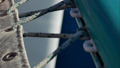 Close-up-of-the-rope-that-tightens-the-canvasof-a-catamaran´s-bow