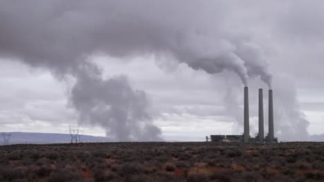 Smoke-rises-from-a-factory-on-a-barren-landscape