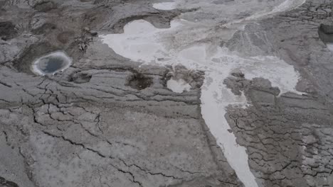 flood-water-fill-small-sinkholes,-in-the-dead-sea-desert,-aerial-shot