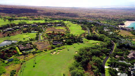 Drone-footage-over-a-golf-course-with-a-pan-over-to-Hapuna-Beach