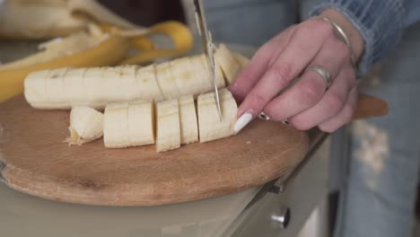 Close-up-scene-of-a-woman-cutting-a-banana