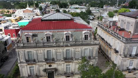 Aerial-trucking-to-left-with-turn-at-end-of-the-Casa-Gemalas,-twin-houses-on-the-Paseo-Montejo-in-Merida,-Yucatan,-Mexico