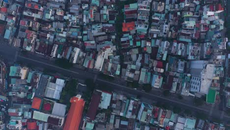 early-morning-top-down-drone-view-of-streets-and-rooftops-in-a-busy-and-densely-populated-area-featuring-main-roads-and-church-building
