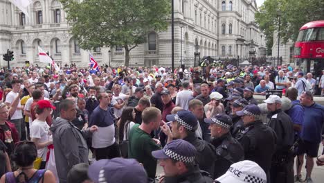 Tommy-Robinson-supporters-chant-England-and-argue-with-police-along-Whitehall,-London