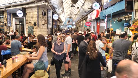 Crowded-Mahane-Yehuda-Market,-Jerusalem,-people-shopping,-eating-food,-walking