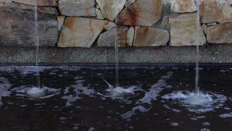 Rocky-urban-water-fountain-has-three-identical-water-spouts