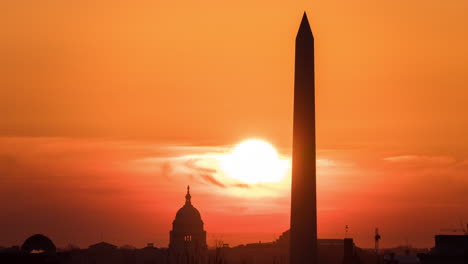 Timelapse-of-the-the-sun-rising-behind-the-Capitol-Building-and-the-Washington-Monument-in-Washington-DC-as-seen-from-the-United-States-Marine-Corps-War-Memorial-in-Arlington-County,-Virginia