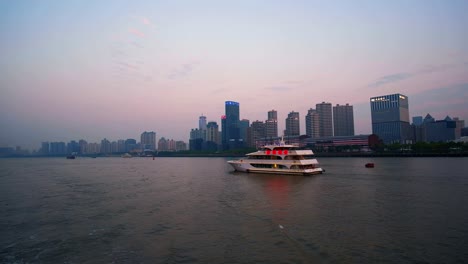 Ein-Sightseeing-Boot-Nimmt-Touristen-Mit-Auf-Eine-Abendliche-Tour-über-Shanghais-Berühmten-Huangpu-Fluss-Und-Besticht-Durch-Die-Spektakulären-Lichter-Der-Nahegelegenen-Geschäftsgebäude