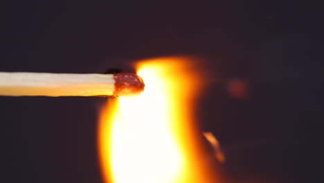 Ignition-matches-close-up-macro-shot-from-side-view-captured-in-front-of-black-background-in-slow-motion-at-60-fps