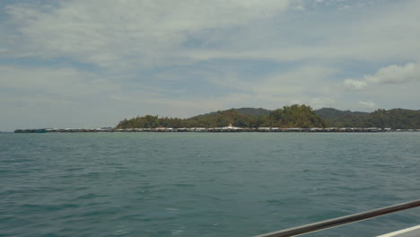 Stilt-house-village-in-the-ocean-off-Borneo-island-seen-from-speedboat