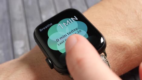 Man-using-the-breath-app-on-his-smartwatch
