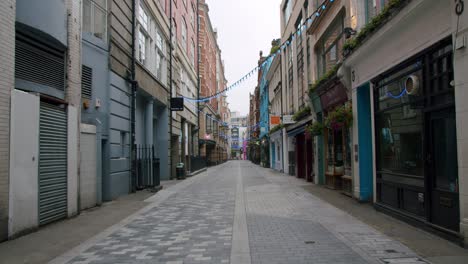 Lockdown-in-London,-slow-motion-gimbal-walk-of-closed-shops-in-empty-Carnaby-Street,-during-2020's-COVID-19-pandemic