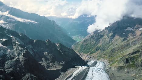 Arerial-dolly-shot-of-the-valley-of-Grindelwald-from-the-alps-range-with-the-glacier