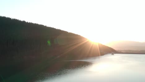 Aerial-shot,-Frumoasa-Dam-Romania-with-bright-sunset-and-lens-flare