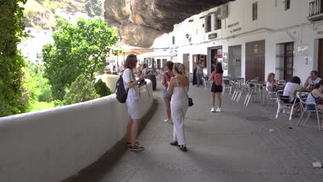 Lost-tourists-stop-to-ask-for-directions-in-Setenil-de-las-Bodegas,-Spain