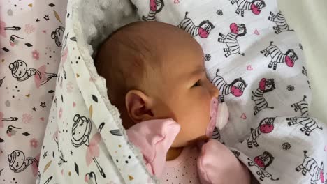 Baby-Girl-Lying-Peacefully-While-Sucking-Her-Pacifier