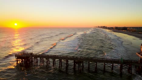 Aerial-sunrise-pull-back-shot-at-Daytona-Beach-shores