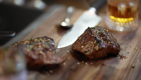 Herb-crusted-steak-sitting-on-a-walnut-cutting-board