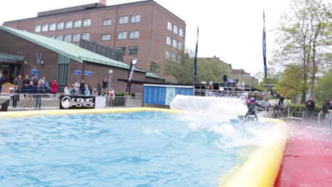 Redbull-sponsored-Wakeboarder-doing-tricks-in-the-air-and-lands-in-a-big-pool-of-water