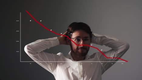 Young-businessman-looks-scared-at-graph-with-red-falling-curve