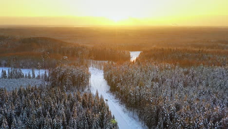 Beautiful-sunset-over-snowy-forest,-HDR-4K-winter-aerial-view