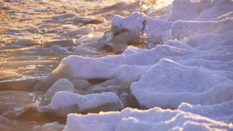 Sea-waves-crashing-against-glacial-ice,-global-warming-melting-arctic-ice