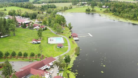 Luxurious-modern-villa-on-lake-coastline-in-aerial-top-down-drone-view