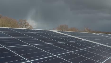 Storm-clouds-time-lapse-over-solar-farm-panels,-renewable-sustainable-energy