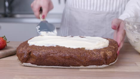 Pastry-Chef-Spreading-Icing-On-Top-Of-Carrot-Cake-Using-Spatula