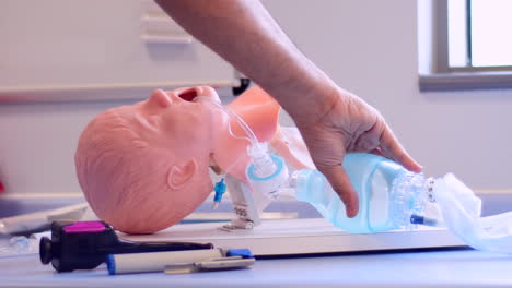 An-intubated-medical-paediatric-manikin-being-ventilated-with-a-bag-valve,-self-inflating-bag