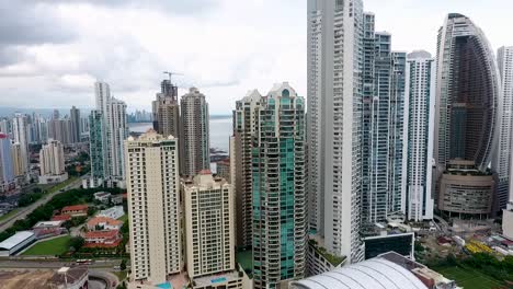 Aerial-drone-footage-of-buildings-in-Panama-City-in-front-of-the-sea-with-camera-panning