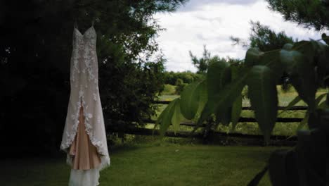 Gorgeous-reveal-of-a-designer-fashion-wedding-dress-in-the-middle-of-the-fenced-back-yard-at-the-Strathmere-Wedding-Resort-and-Spa-in-Ottawa,-Ontario,-Canada