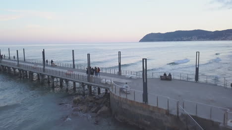 People-at-Alassio-pier-by-the-sea-in-Liguria,-Northern-Italy
