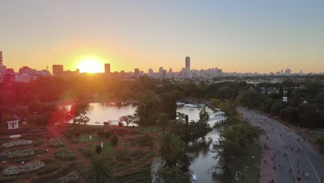 Aerial-dolly-in-flying-over-Rosedal-gardens-pond-near-Palermo-Woods-pedestrian-street-at-sunset,-Buenos-Aires