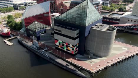 National-Aquarium-in-Inner-Harbor,-USS-Torsk-submarine,-Baltimore,-MD-as-seen-from-drone,-aerial-overhead-orbiting-view
