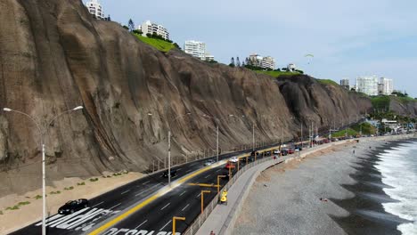 Boom-job-down-4k-aerial-video-of-the-Miraflores-coast-in-Lima,-Peru,-in-a-summer-sunny-day