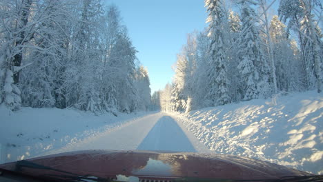 Windscreen-view-driving-through-a-beautiful-snowy-winter-wonderland