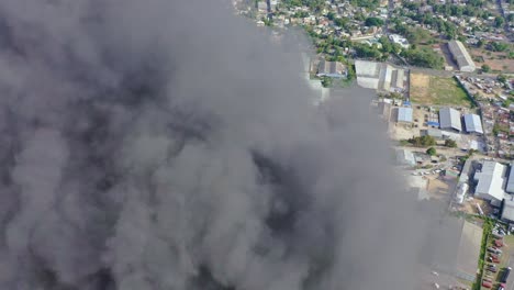 Drone-flying-through-big-column-of-rising-smoke-of-building-fire