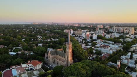 Aerial-dolly-out-of-San-Isidro-Cathedral-and-Buenos-Aires-city-on-background-at-sunset