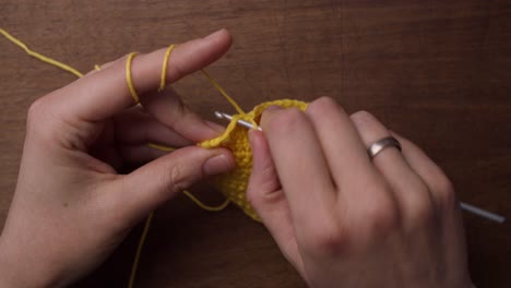 Close-up-top-shot-of-caucasian-hands-doing-some-needle-work:-crochet