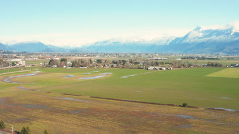 Aerial-rise-over-farm-land-in-Chilliwack,-British-Columbia