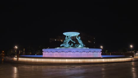 The-Triton-Fountain-illuminated-at-night-in-Valletta,-Malta,-famous-city-landmark-and-tourist-attraction