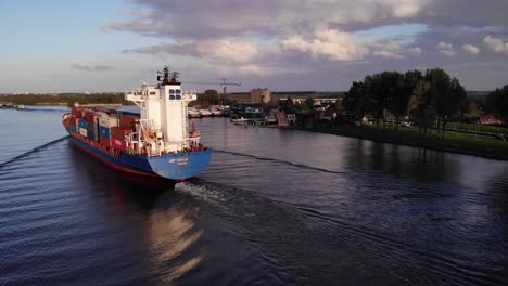 JSP-Carla-Dutch-Vessel-Transporting-Shipping-Containers-By-Inland-River-In-Puttershoek,-Netherlands