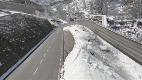 High-speed-turns-whilst-a-Ferrari-takes-curves-on-a-snowy-mountain-road