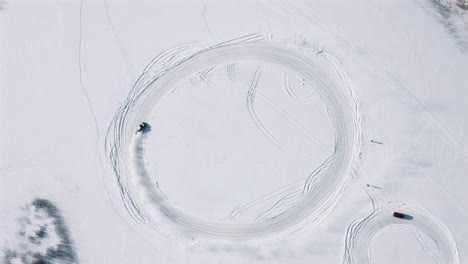 Drone-footage-of-Porsche-carrera-2020-911-4S-drifting-on-frozen-Lake-in-circle-shaped-track