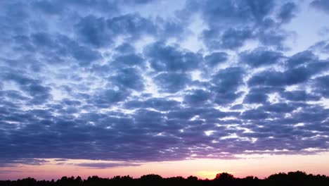 Wunderschöner,-Lebendiger,-Kontrastreicher-Rosa-violetter-Sonnenuntergang-Aus-Der-Luft-Mit-Blauen-Wolken-über-Der-Ostsee-Bei-Liepaja,-Entfernte-Schiffe-Im-Meer,-Aufsteigende-Weitwinkel-Drohnenaufnahme,-Kamera-Nach-Unten-Geneigt