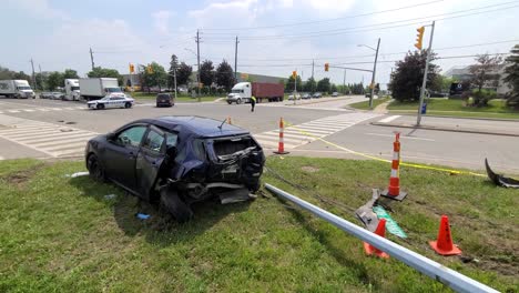 Static-view-of-vehicles-collision-at-the-intersection-of-Bovaird-Drive-East-Brampton-Canada-on-6th-June-2021,-car-remains-at-the-scene-and-police-car-blocked-at-the-intersection-to-control-traffic
