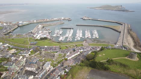 Aerial-View-Of-Howth-Village-Near-Howth-Pier-With-Boats-And-Ireland's-Eye-At-Daytime-In-Dublin,-Ireland