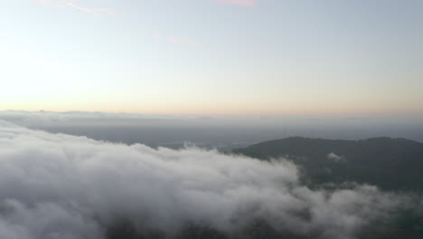 Drohnenaufstieg-Und-Blick-Nach-Links-über-Niedrige-Wolken-Und-Fernsehtürme-In-Der-Abenddämmerung
