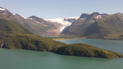 Aerial-shot-of-Svartisen-Blackice-Glacier-beside-idyllic-Fjord-during-sunlight---Helgeland,-Northern-Norway
